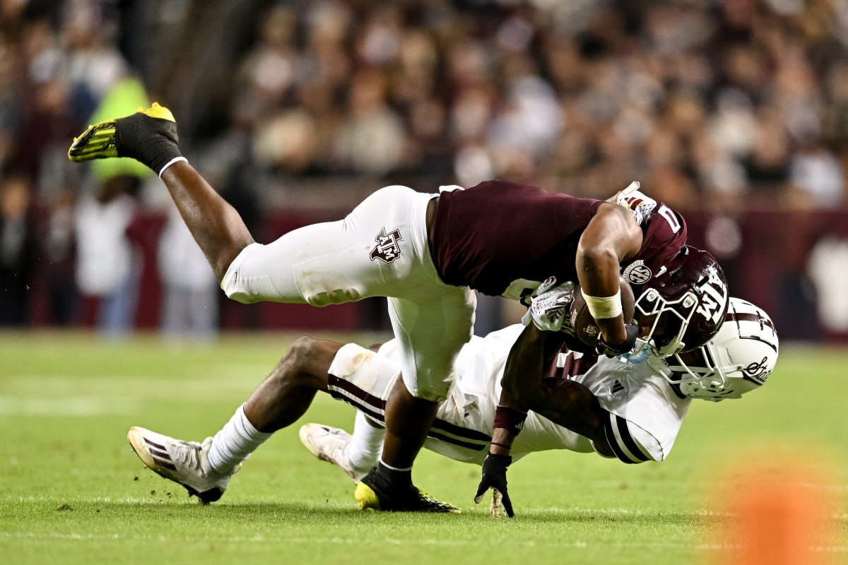 Mississippi State Bulldogs cornerback Decamerion Richardson tackles Texas A&M wide receiver Ainias Smith.